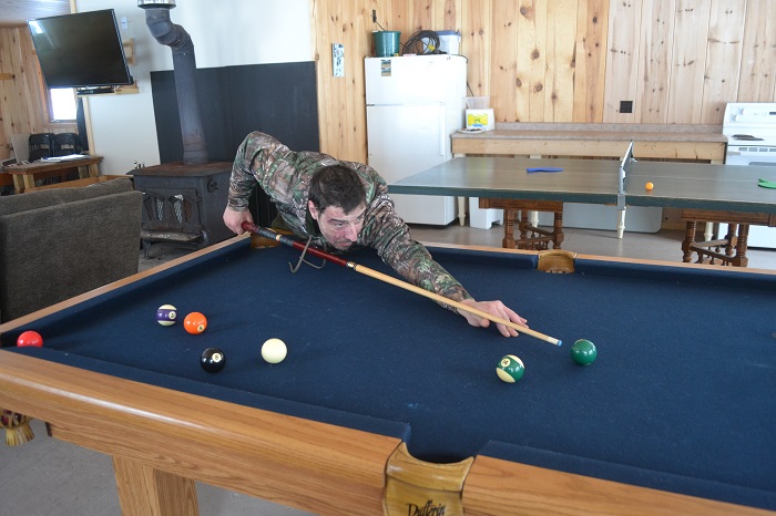 Playing pool in a recreation hall