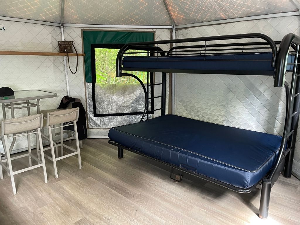 Bunkbed and table inside of a yurt