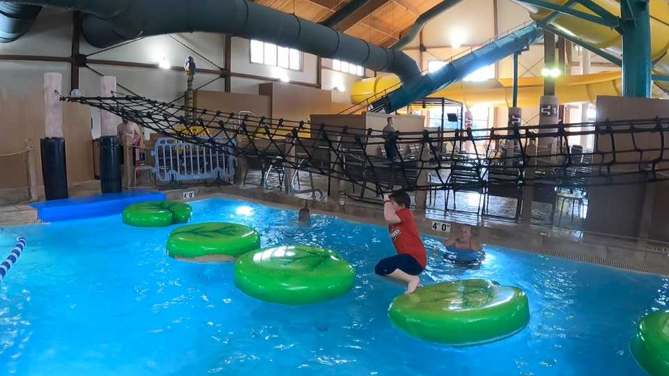 A child hopping from one lily pad to the next. Big Foot Pass at Great Wolf Lodge in Traverse City, Michigan.