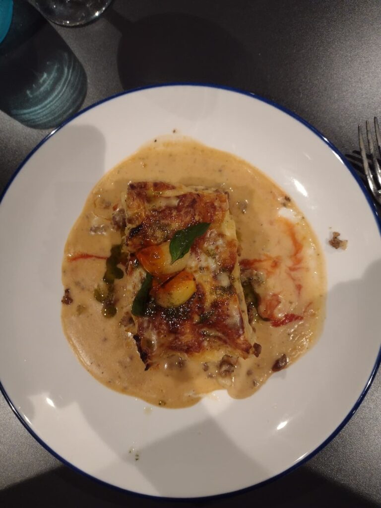 Hearty slice of baked lasagna layered with meat, cheese, and marinara sauce