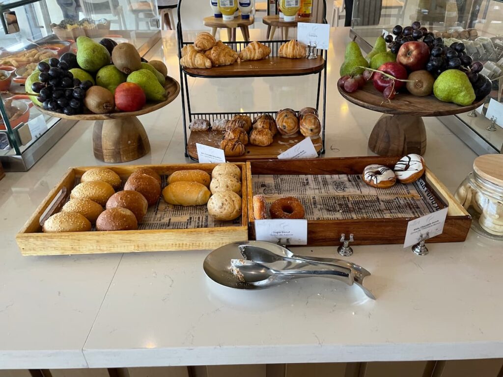  Elegant dessert display at Dreams Flora’s Preferred Club Lounge with cakes, tarts, and bite-sized sweets.