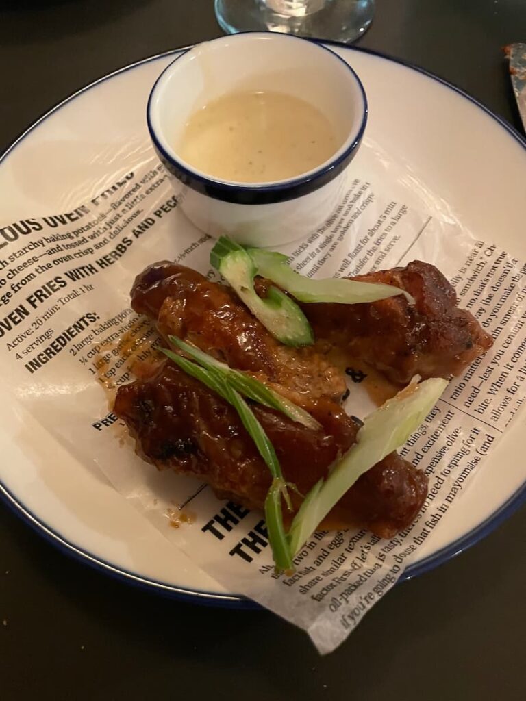 Spicy chicken wings coated in sauce, served with celery sticks and ranch dressing.