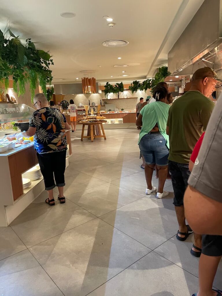 Buffet dining area at World Café in Dreams Flora with colorful dishes, family-friendly seating, and tropical decor.