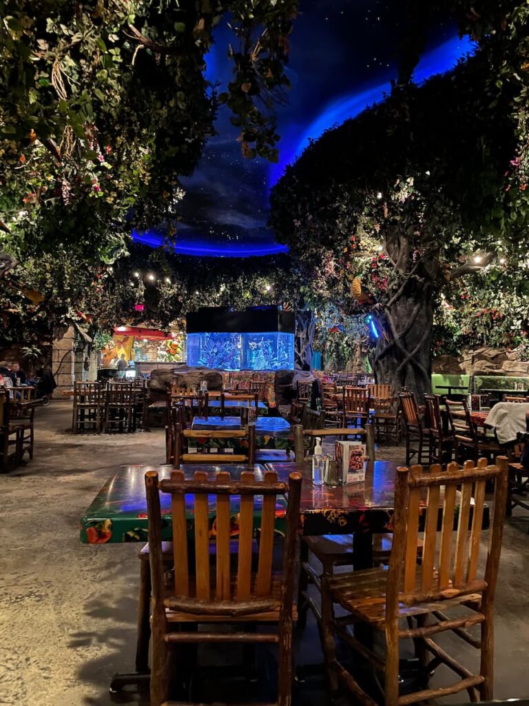 Interior of Rainforest Cafe in Niagara Falls featuring lush jungle decor, animatronic animals, and vibrant tropical atmosphere.