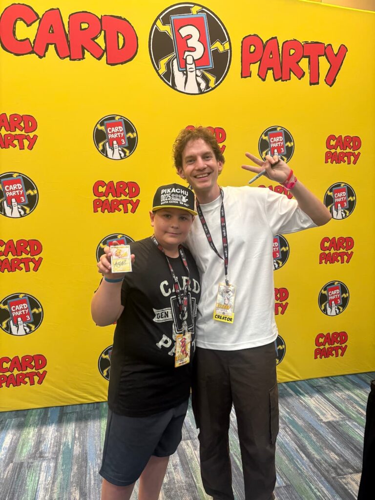 Smiling fan meeting Unlistedleaf at Card Party 3 in Tampa, posing together in front of the convention center backdrop.