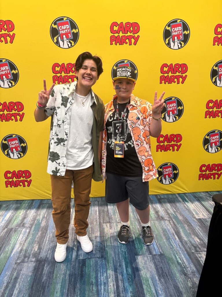 Fan meeting SuperDuperDani at Card Party 3 in Tampa, smiling and posing together in the fun, Pokémon-filled environment.